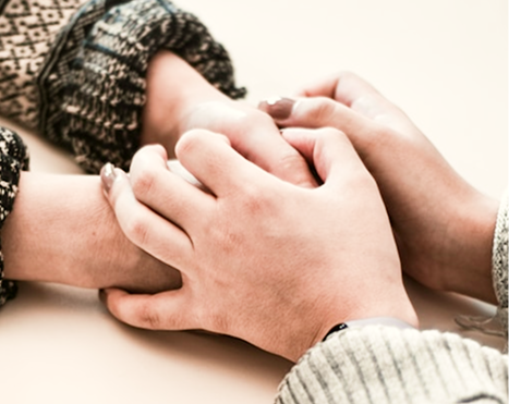 two women holding hands