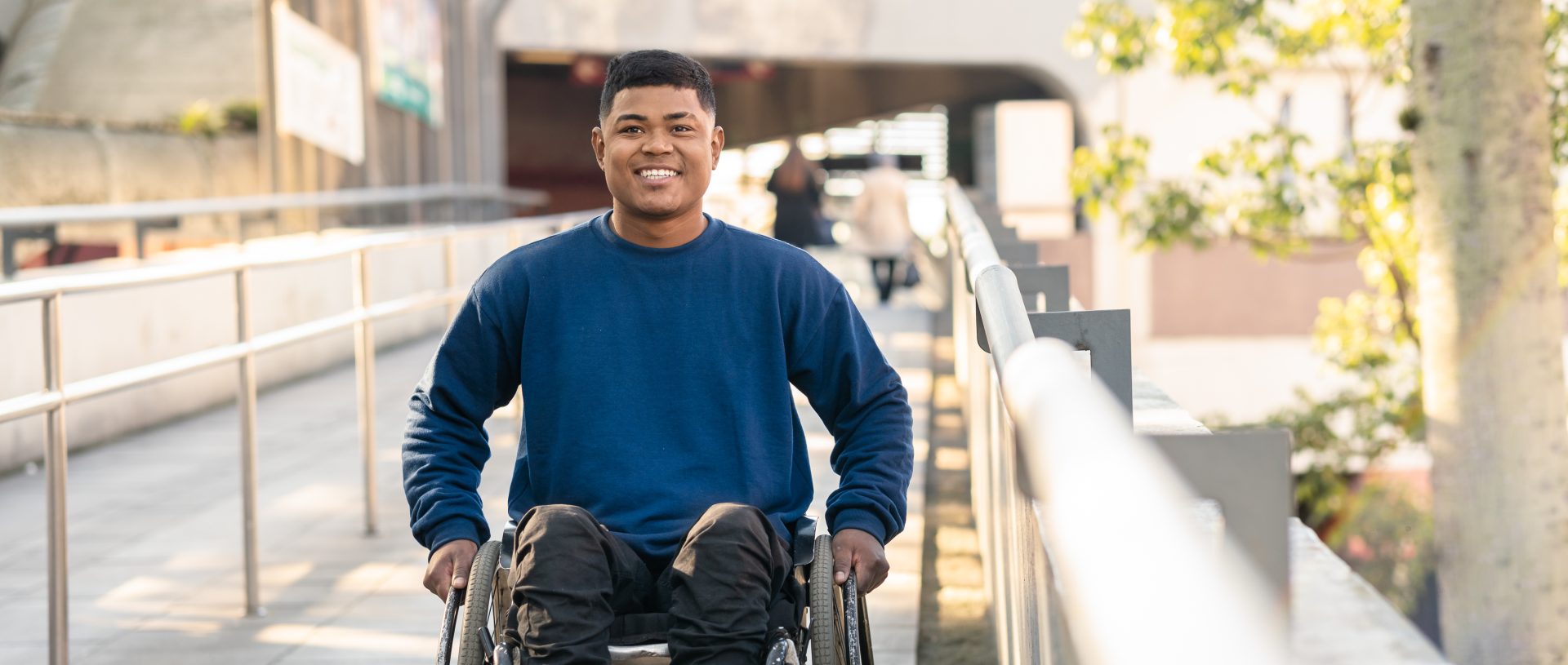 Portrait Of Man in Wheelchair Smiling And Looking At Camera