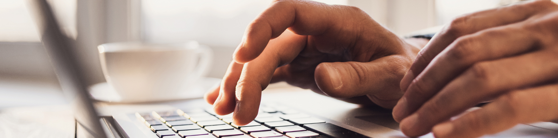 hands typing on a laptop