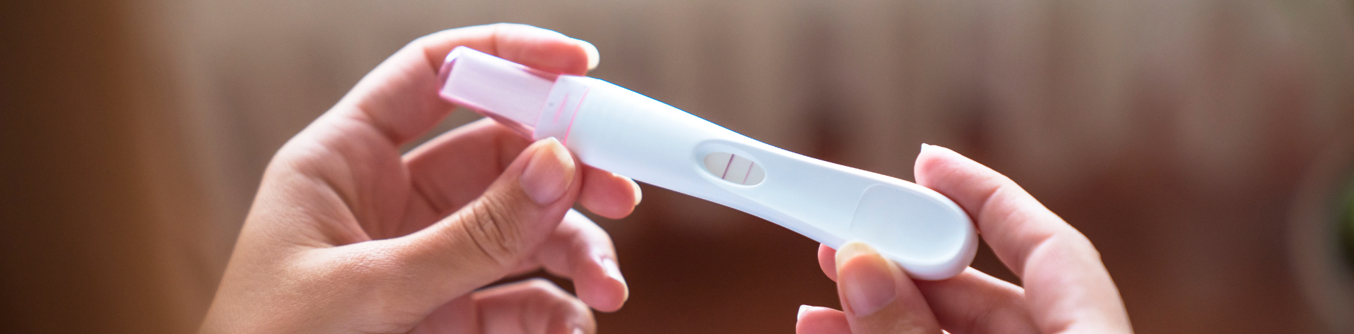 woman holding pregnancy test
