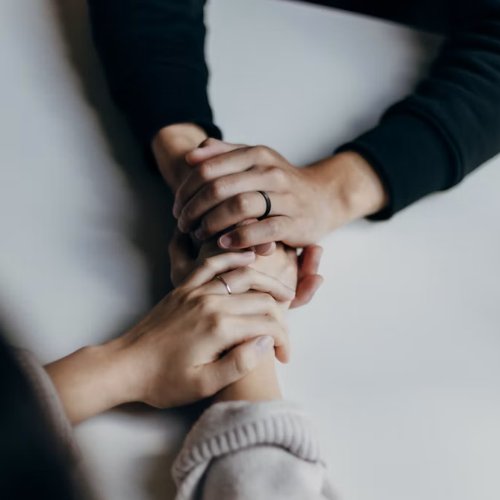 offering support by holding hands