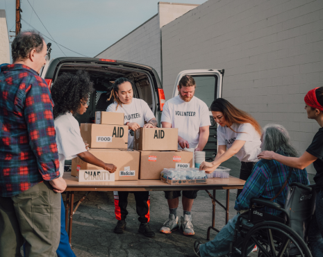 volunteers passing out resources to community from car