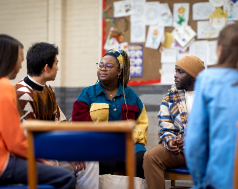 community of people sitting and discussing topics