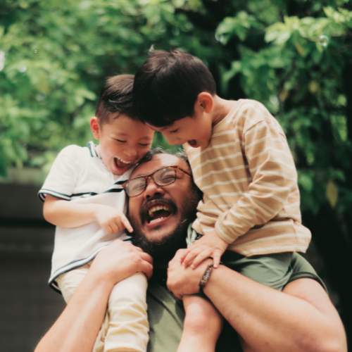 men with two children on shoulders