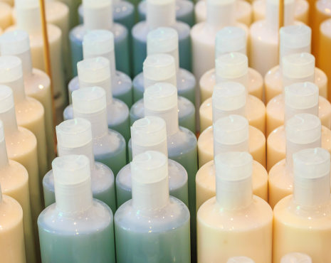 multiple shampoo bottles lined up blue and orange