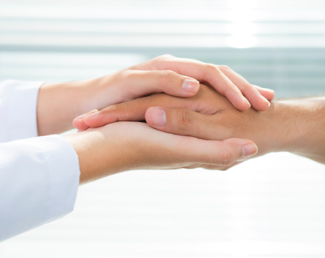 a pair of hands holding one hand