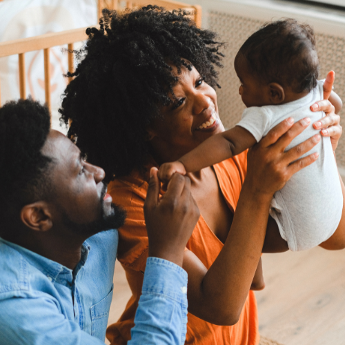 young couple making baby laugh