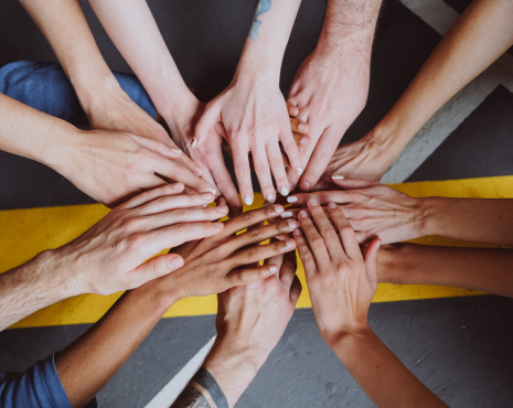 a team bringing their hands together