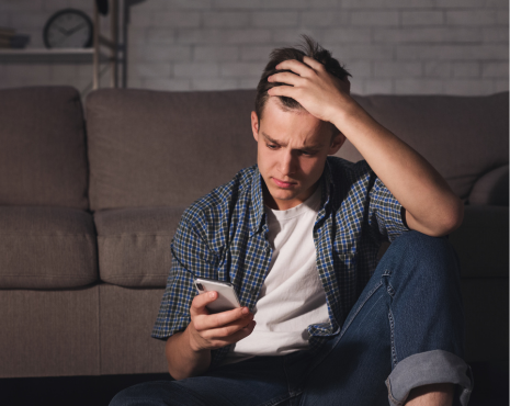 a man in distress holding a phone