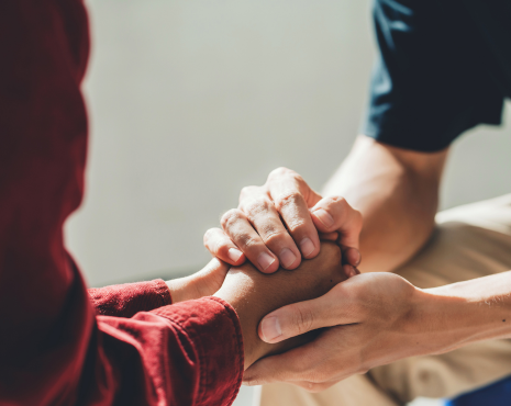 counselor holding a patient's hand