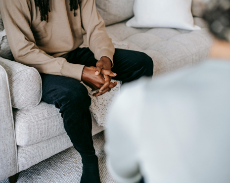 man in therapist office speaking with counselor