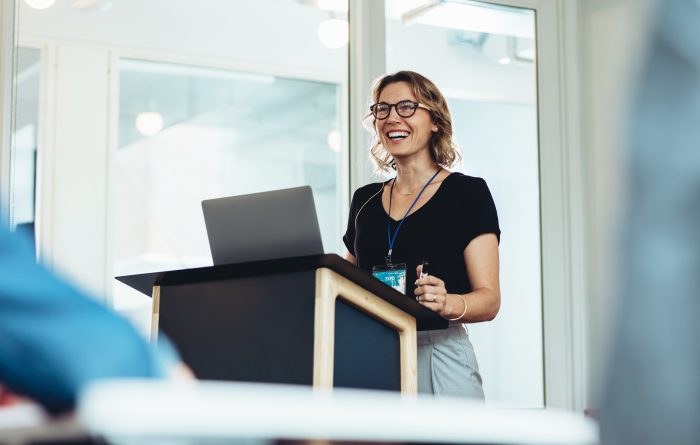 woman giving presentation in conference room