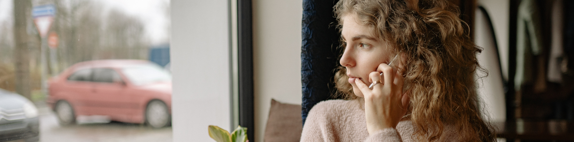 Woman calling while looking out window